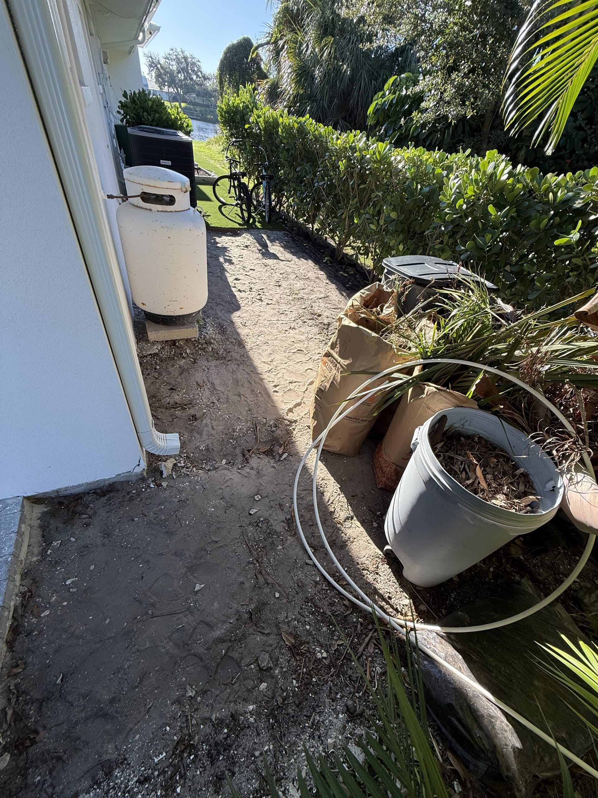 Old debris and an unused propane tank cleared from the yard