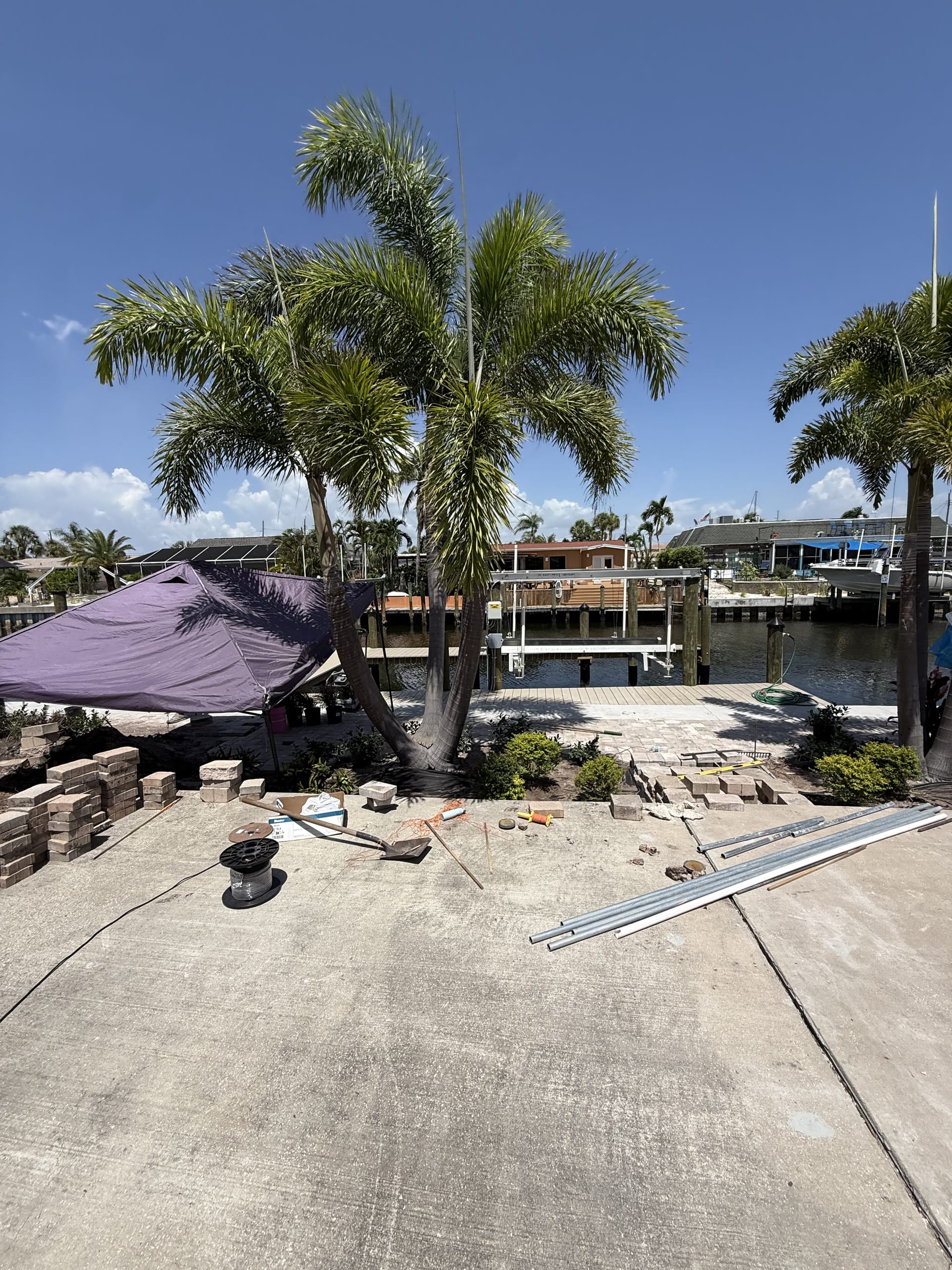 Tropical beds and lighting being installed around the new patio